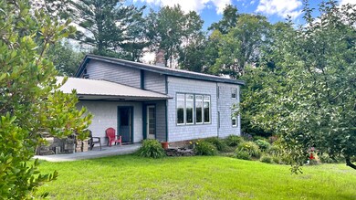 7. Back of home has gardens and patio ar