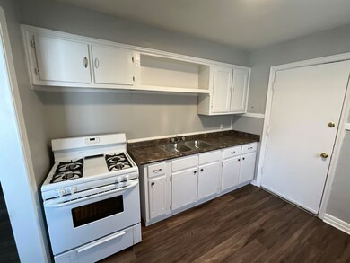 Kitchen featuring open shelves, white gas range, d