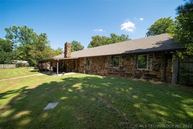 Back of home with covered patio for sitting out an