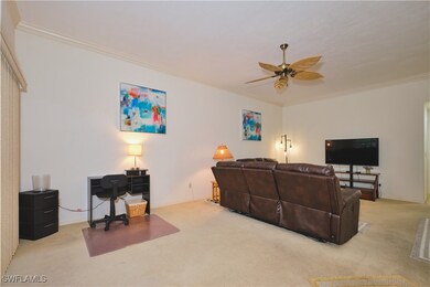 Living room featuring carpet flooring, crown moldi