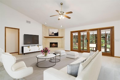 Follow the natural flow into a generous family room featuring a floor to ceiling BRICK FIREPLACE and French door access to a SCREENED LANAI. Virtually Staged.