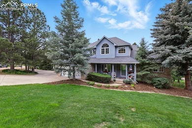 This dreamy traditional-style home features a circular driveway and a lush, beautiful lawn.