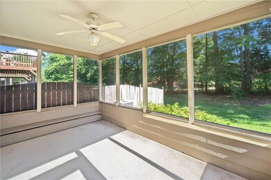 Unfurnished sunroom with a ceiling fan and healthy amount of natural light