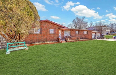 Ranch-style home with a garage, concrete driveway,