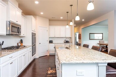 Another view of kitchen showing the hardwood floor