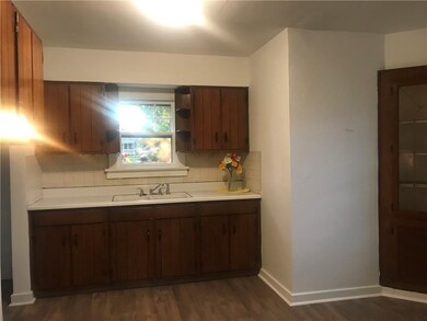 Eat in kitchen offering fresh paint and new vinyl laminate floor covering.