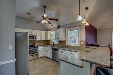 Kitchen featuring decorative light fixtures, stain