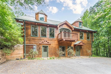 View of front of home featuring a balcony and fenc