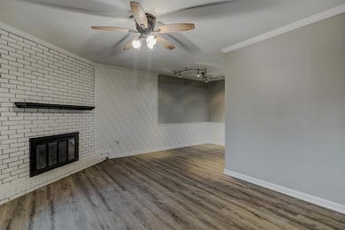 Unfurnished living room featuring ornamental moldi