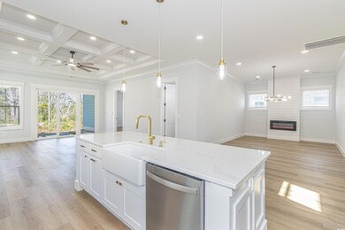 Kitchen featuring open floor plan, a center island with sink, and stainless steel dishwasher