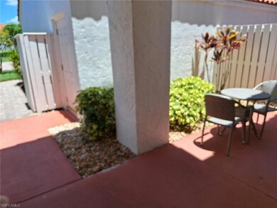 View of patio front gate and garage entry