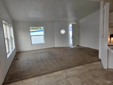 Unfurnished living room with light colored carpet