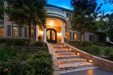 The custom iron front door welcomes you into this 