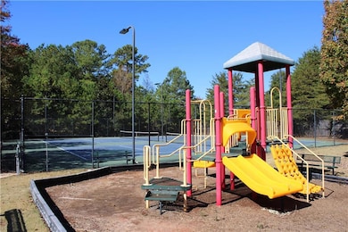 Community playground with a tennis court