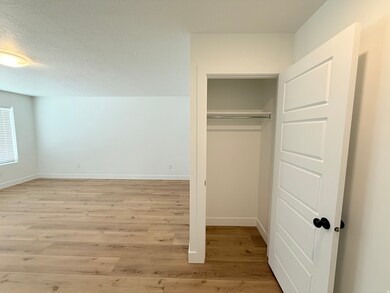 Coat closet in spacious entry/living room. Laminate floors throughout