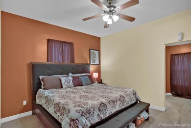 Carpeted bedroom with ceiling fan