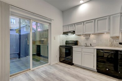 Kitchen with tile floors, dishwasher, refrigerator