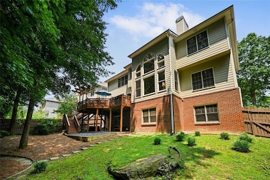 The rear deck overlooks a  serence backyard