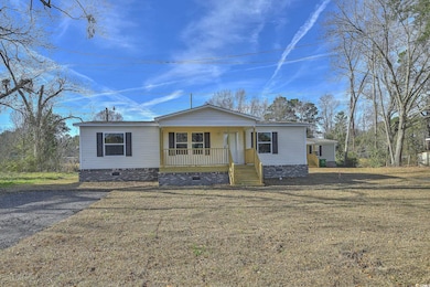 Manufactured / mobile home featuring crawl space, a front lawn, and a porch