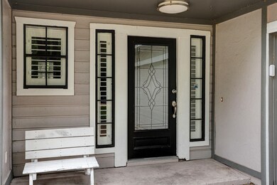 Front porch area has room for a bench or large flo