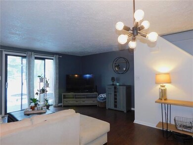 Living room has sliding door leading to patio.