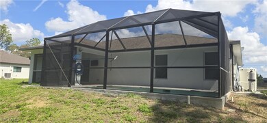 Back of property with glass enclosure, a shingled