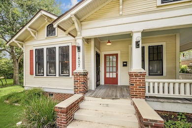 The welcoming front porch features two doors to th