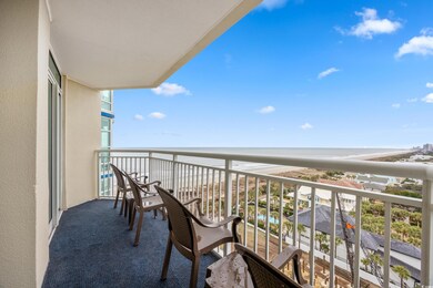 Balcony with a water view and a beach view