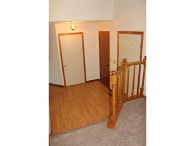Foyer with laminated wood flooring.