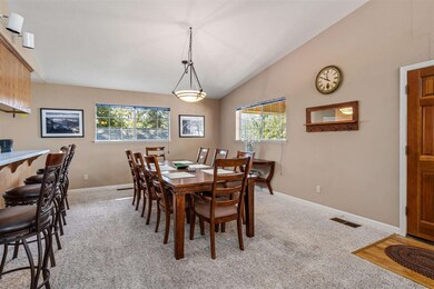 Dining room featuring light carpet and high vaulted ceiling