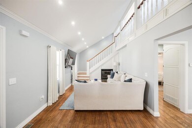 Living room featuring baseboards, a glass covered 