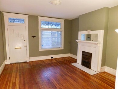 The living room overlooks the front porch and has 