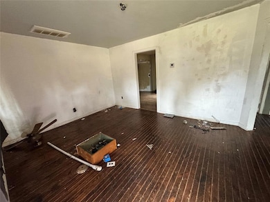 Spare room featuring dark wood-style floors