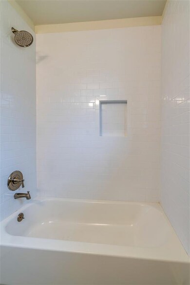 New shower tub combo with tile surround.  Bath is equipped with an vent fan to get out steam and keep the mirror from fogging.