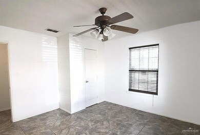 Spare room featuring ceiling fan and stone finish flooring