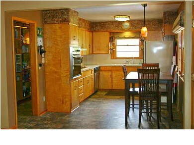 The kitchen features a floating vinyl floor, built