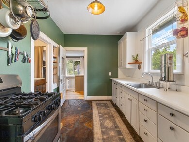 The kitchen has been updated to a gas range / oven