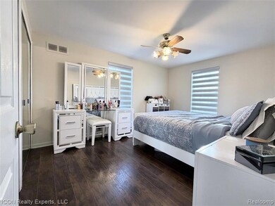Bedroom with dark wood-style floors and a ceiling fan