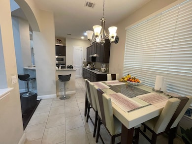 Dining area with a chandelier, arched walkways, a