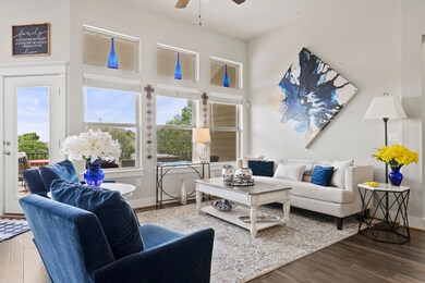 Living area with a ceiling fan, wood finished flo