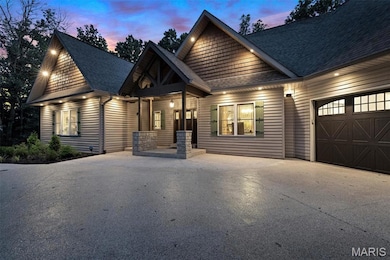 View of front of home featuring a shingled roof, an attached garage, concrete driveway, and a porch