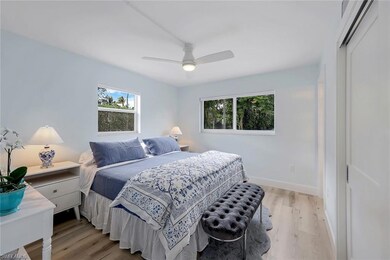 Bedroom featuring multiple windows, ceiling fan, l