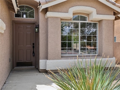 Property entrance featuring stucco siding