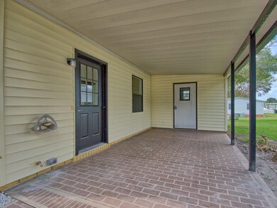 View of 1 CAR CARPORT with PAINTED DRIVEWAY. BROWN