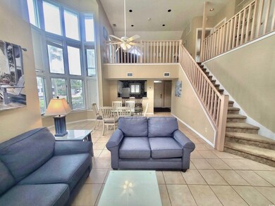 Living room featuring ceiling fan, tile patterned 