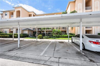 View of parking / parking lot featuring a carport