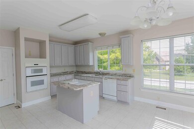 Kitchen has stunning granite, built in ovens, elec