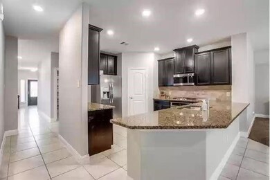 Kitchen with recessed lighting, light tile pattern