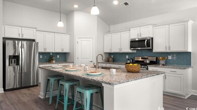 Kitchen featuring stainless steel appliances, tast