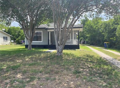 Obstructed view of property with a porch and a fr